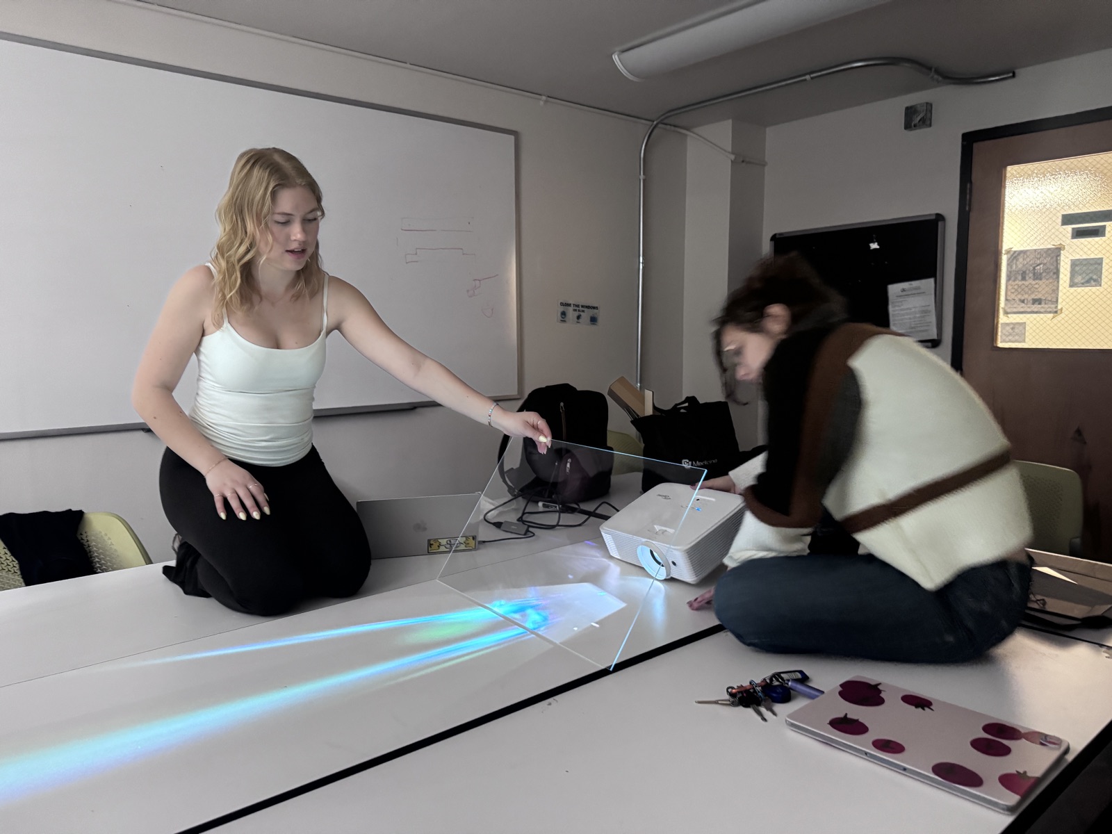 Teammates testing the acrylic screen and projector setup